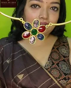Brass hasuli with a multicolour stone flower, worn